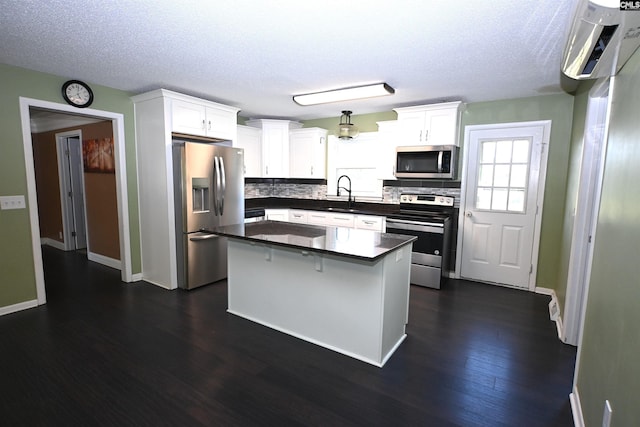 214 Mac St, Leesville, SC 29070 - kitchen with appliances with stainless steel finishes, decorative backsplash, dark countertops, white cabinets, and dark wood-style flooring