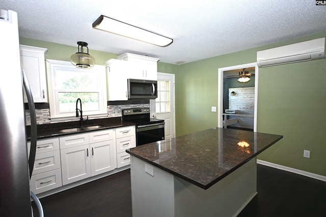 214 Mac St, Leesville, SC 29070 - kitchen with stainless steel appliances, a wall unit AC, dark wood-type flooring, tasteful backsplash, and a textured ceiling