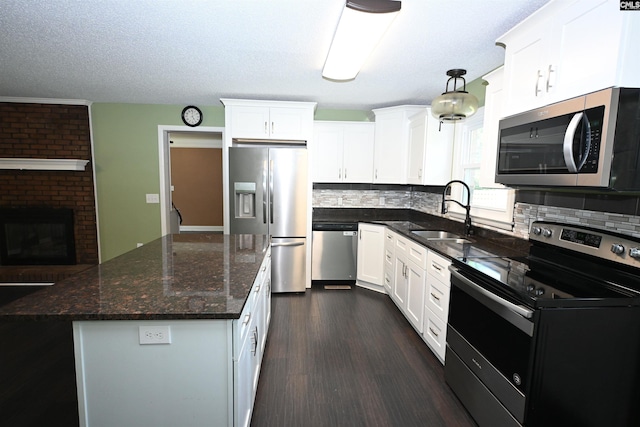 214 Mac St, Leesville, SC 29070 - kitchen with stainless steel appliances, tasteful backsplash, dark wood-style flooring, white cabinets, and a kitchen island
