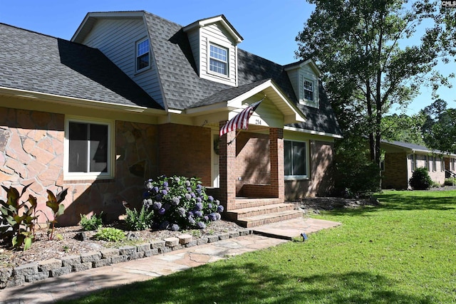 214 Mac St, Leesville, SC 29070 - view of front of home featuring roof with shingles, a front lawn, stone siding, and brick siding