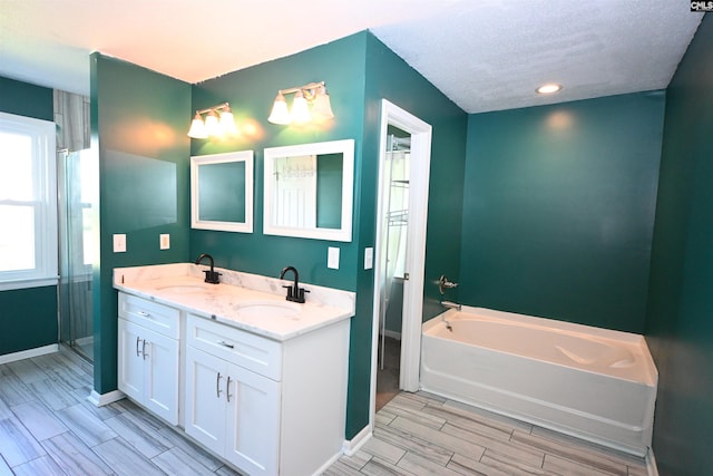214 Mac St, Leesville, SC 29070 - full bathroom featuring a garden tub, double vanity, wood finish floors, a stall shower, and recessed lighting