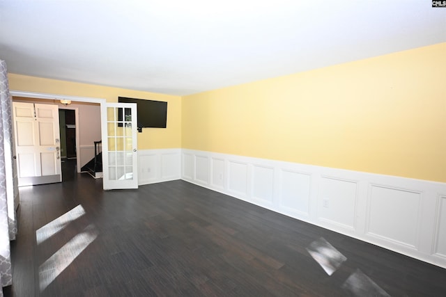 214 Mac St, Leesville, SC 29070 - spare room featuring a wainscoted wall, dark wood-type flooring, french doors, and a decorative wall