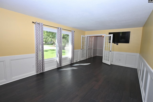 214 Mac St, Leesville, SC 29070 - unfurnished room featuring french doors, wainscoting, dark wood-style flooring, and a decorative wall
