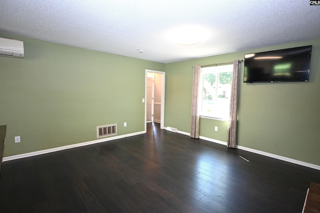214 Mac St, Leesville, SC 29070 - unfurnished room featuring wood finished floors, a wall unit AC, and a textured ceiling