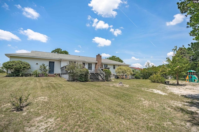 122 Partridge Hill Dr, West Columbia, SC 29172 - back of property featuring a wooden deck, a yard, a chimney, and a playground