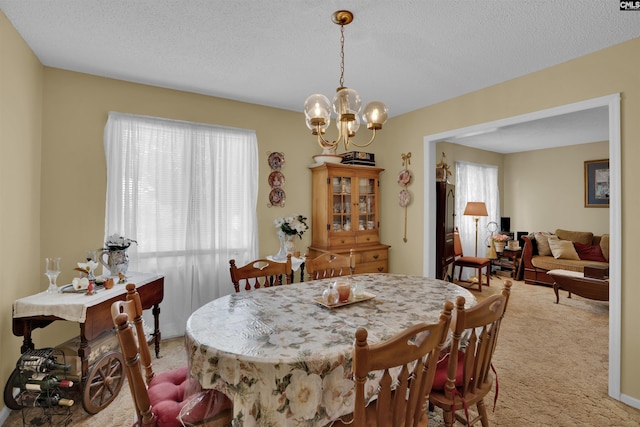 122 Partridge Hill Dr, West Columbia, SC 29172 - dining space featuring light colored carpet, a textured ceiling, and a chandelier