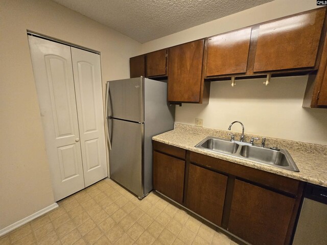 3630 Ranch Rd Unit 5-6, Columbia, SC 29206 - kitchen with appliances with stainless steel finishes, light countertops, light floors, dark brown cabinetry, and a textured ceiling