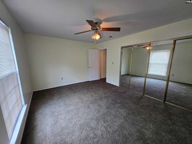 3630 Ranch Rd Unit 11-8, Columbia, SC 29260 - unfurnished bedroom with multiple windows, dark carpet, a closet, and a ceiling fan
