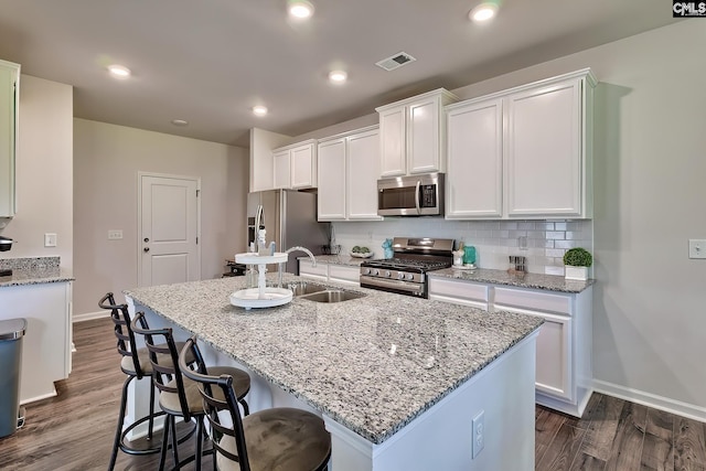 142 Summer Orchard Dr, Lexington, SC 29072 - kitchen with stainless steel appliances, white cabinets, dark wood-type flooring, an island with sink, and recessed lighting