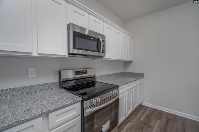 739 Wild Duck Ln, Columbia, SC 29203 - kitchen featuring stainless steel appliances, dark wood-style flooring, white cabinets, and light stone countertops