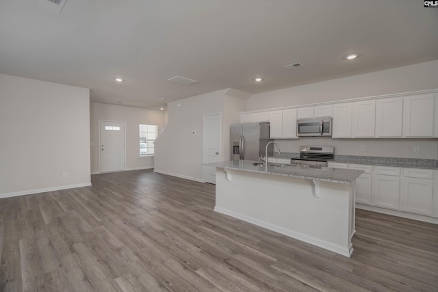 739 Wild Duck Ln, Columbia, SC 29203 - kitchen featuring stainless steel appliances, a kitchen island with sink, dark wood finished floors, white cabinetry, and recessed lighting