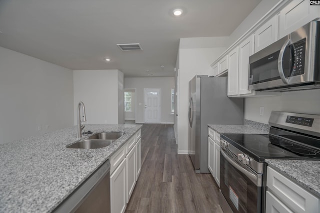 739 Wild Duck Ln, Columbia, SC 29203 - kitchen with appliances with stainless steel finishes, dark wood-style floors, white cabinetry, light stone countertops, and recessed lighting