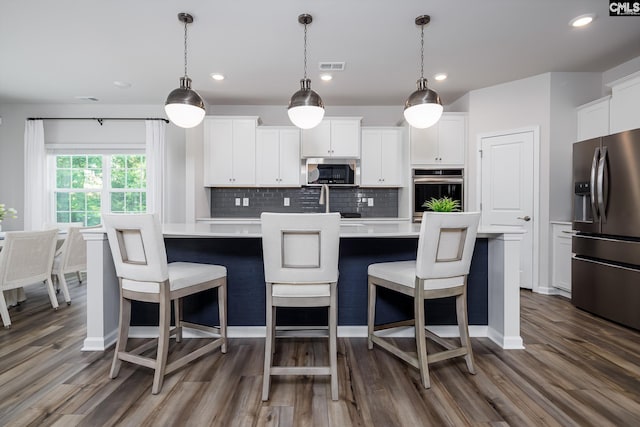186 Backspin Dr, Elgin, SC 29045 - kitchen featuring appliances with stainless steel finishes, light countertops, dark wood-style flooring, tasteful backsplash, and recessed lighting