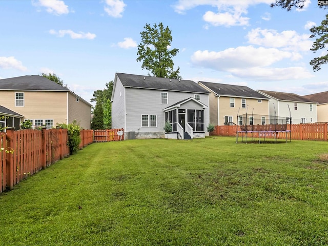 393 Denman Loop, Columbia, SC 29229 - rear view of property featuring a sunroom, a trampoline, and a fenced backyard