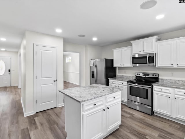 393 Denman Loop, Columbia, SC 29229 - kitchen with appliances with stainless steel finishes, white cabinetry, wood finished floors, a kitchen island, and recessed lighting
