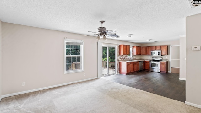 339 Cornflower Dr, Columbia, SC 29229 - kitchen with appliances with stainless steel finishes, dark carpet, ceiling fan, light countertops, and a textured ceiling