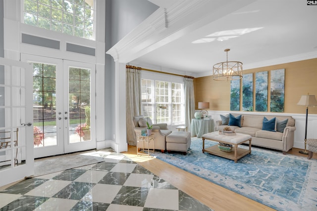 226 Forty Love Pt, Chapin, SC 29036 - living room with plenty of natural light, french doors, ornamental molding, a wainscoted wall, and a chandelier