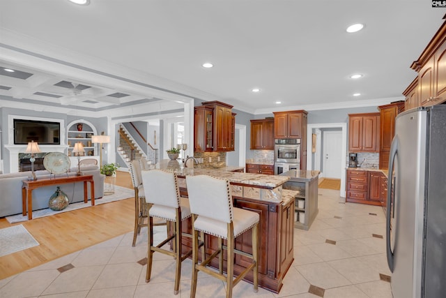 226 Forty Love Pt, Chapin, SC 29036 - kitchen with appliances with stainless steel finishes, a peninsula, ornamental molding, open floor plan, and recessed lighting