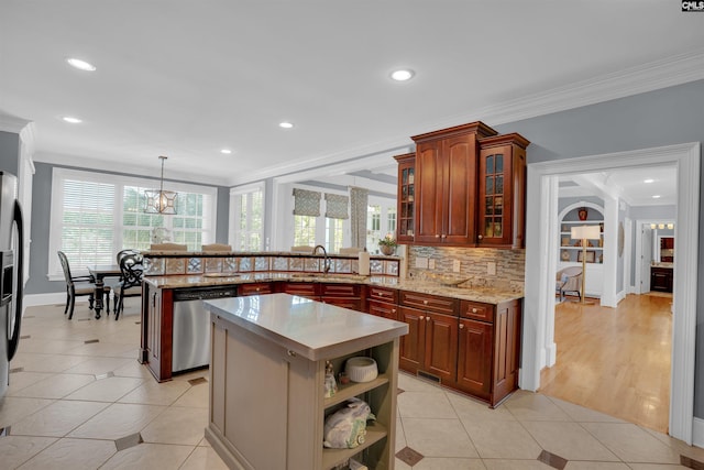 226 Forty Love Pt, Chapin, SC 29036 - kitchen with appliances with stainless steel finishes, a peninsula, crown molding, tasteful backsplash, and decorative light fixtures