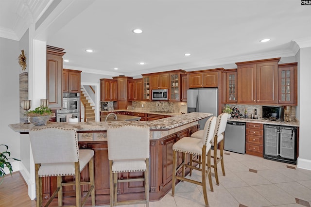 226 Forty Love Pt, Chapin, SC 29036 - kitchen with appliances with stainless steel finishes, beverage cooler, a peninsula, decorative backsplash, and recessed lighting