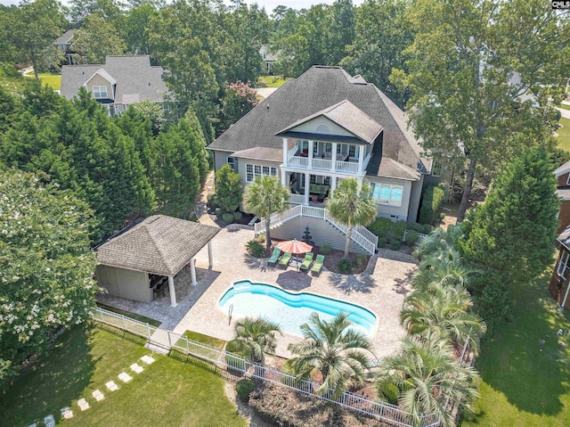 226 Forty Love Pt, Chapin, SC 29036 - rear view of property with a balcony, a fenced backyard, a patio, stairs, and a shingled roof