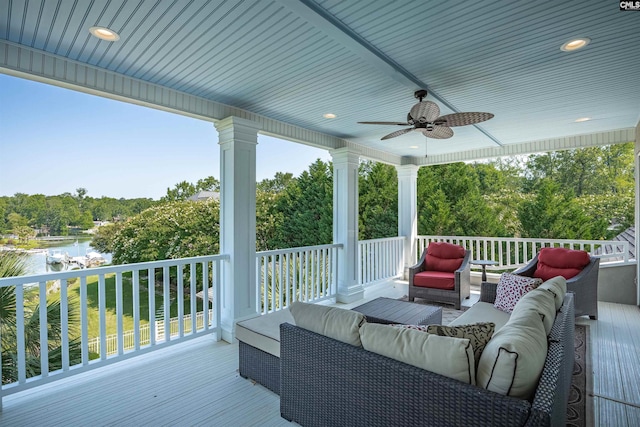 226 Forty Love Pt, Chapin, SC 29036 - wooden terrace featuring outdoor lounge area, a ceiling fan, a water view, and view of wooded area
