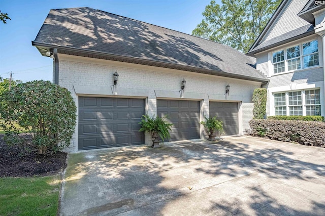 226 Forty Love Pt, Chapin, SC 29036 - view of home's exterior with driveway, brick siding, a garage, and roof with shingles
