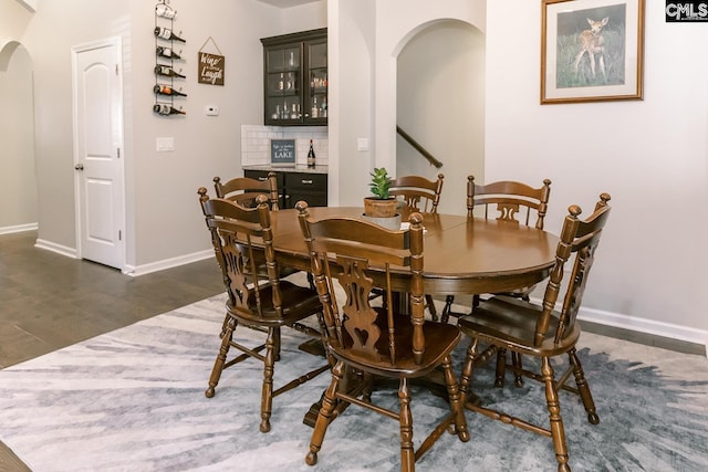 122 Azur Ave, Chapin, SC 29036 - dining space with arched walkways, a dry bar, and dark wood finished floors