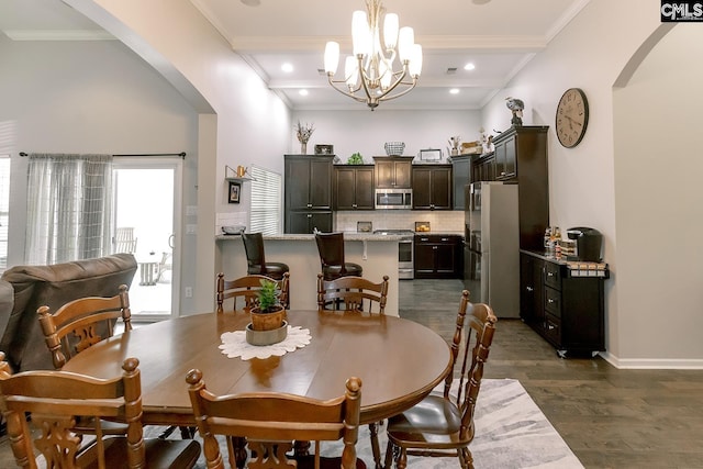 122 Azur Ave, Chapin, SC 29036 - dining space with arched walkways, dark wood finished floors, a chandelier, beam ceiling, and crown molding