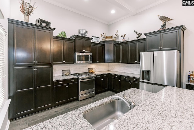 122 Azur Ave, Chapin, SC 29036 - kitchen featuring appliances with stainless steel finishes, wood finished floors, tasteful backsplash, crown molding, and light stone counters