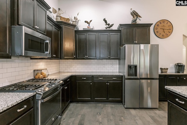 122 Azur Ave, Chapin, SC 29036 - kitchen with stainless steel appliances, wood finished floors, backsplash, and light stone counters