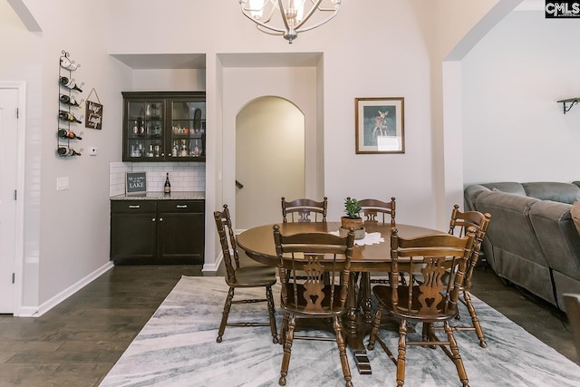 122 Azur Ave, Chapin, SC 29036 - dining space featuring arched walkways, dark wood-style flooring, bar, and a chandelier