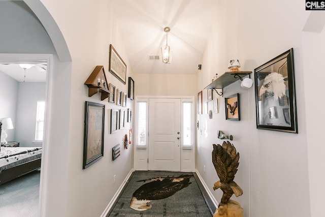 122 Azur Ave, Chapin, SC 29036 - entryway featuring dark carpet, healthy amount of natural light, arched walkways, and lofted ceiling