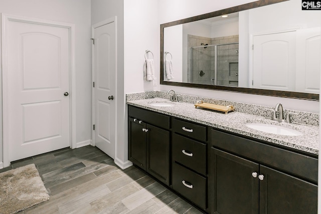 122 Azur Ave, Chapin, SC 29036 - bathroom featuring a stall shower, double vanity, ornamental molding, and wood finished floors