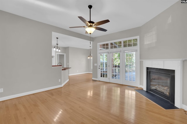 100 Ridge Top Rd, Lexington, SC 29072 - unfurnished living room with wood finished floors, a glass covered fireplace, and a ceiling fan