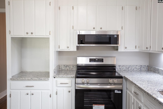 320 Perkins Ln, Camden, SC 29020 - kitchen with appliances with stainless steel finishes, white cabinets, and light stone countertops