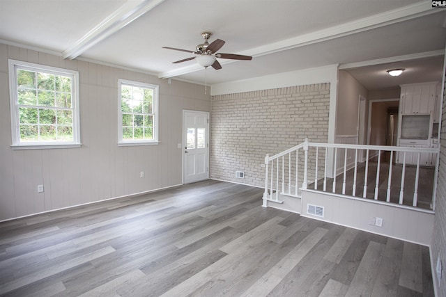 320 Perkins Ln, Camden, SC 29020 - empty room featuring wood finished floors, a ceiling fan, beam ceiling, brick wall, and crown molding