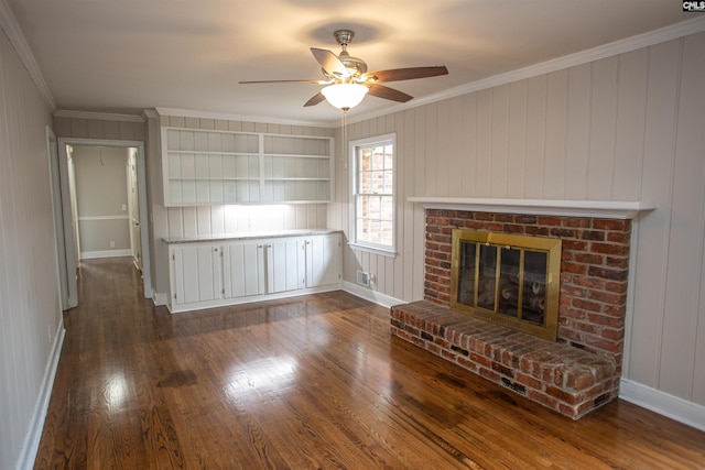 320 Perkins Ln, Camden, SC 29020 - unfurnished living room with dark wood-type flooring, a ceiling fan, a fireplace, ornamental molding, and built in shelves