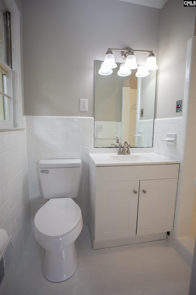 320 Perkins Ln, Camden, SC 29020 - bathroom featuring tile walls, a wainscoted wall, vanity, and tile patterned floors