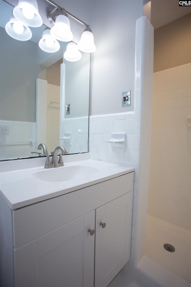 320 Perkins Ln, Camden, SC 29020 - full bathroom with tile walls, vanity, a tile shower, and a wainscoted wall