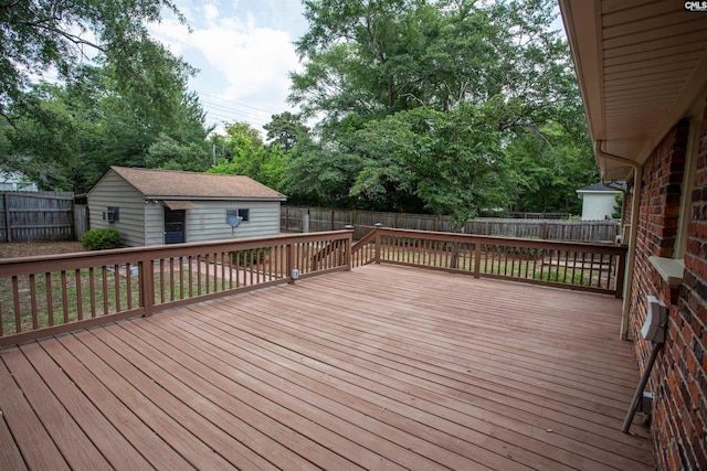 320 Perkins Ln, Camden, SC 29020 - wooden deck with a fenced backyard, an outdoor structure, and view of wooded area