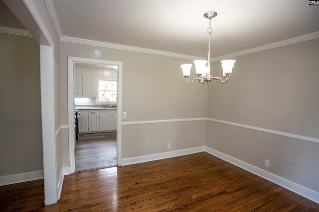 320 Perkins Ln, Camden, SC 29020 - unfurnished room with ornamental molding, dark wood finished floors, a chandelier, and a smoke detector