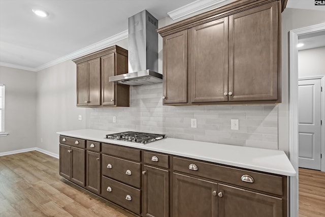 478 Harbour Pointe Dr, Columbia, SC 29229 - kitchen with wall chimney exhaust hood, light wood finished floors, stainless steel gas stovetop, ornamental molding, and light countertops