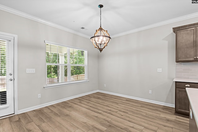 478 Harbour Pointe Dr, Columbia, SC 29229 - unfurnished dining area featuring crown molding, a chandelier, healthy amount of natural light, and light wood-type flooring