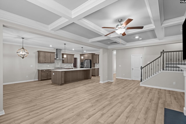 478 Harbour Pointe Dr, Columbia, SC 29229 - kitchen with wall chimney exhaust hood, open floor plan, a ceiling fan, light countertops, and beam ceiling