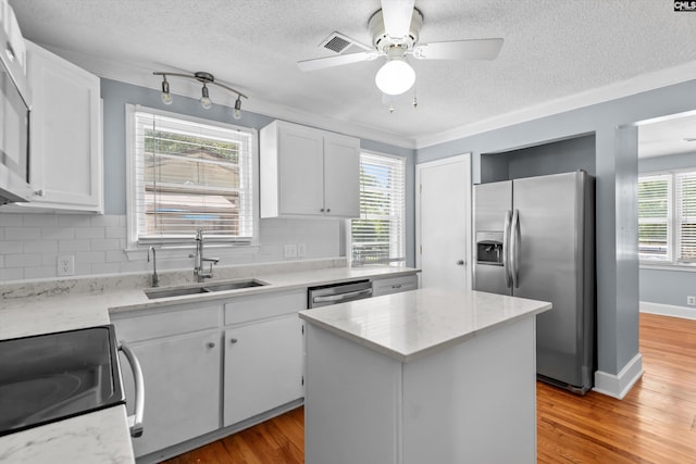 231 Horseshoe Cir, Columbia, SC 29223 - kitchen featuring stainless steel fridge, electric stove, a center island, white cabinets, and a textured ceiling