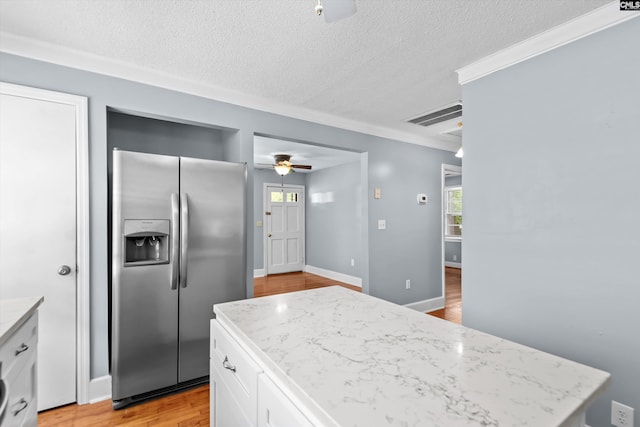 231 Horseshoe Cir, Columbia, SC 29223 - kitchen featuring stainless steel fridge with ice dispenser, a ceiling fan, white cabinetry, light wood-type flooring, and crown molding