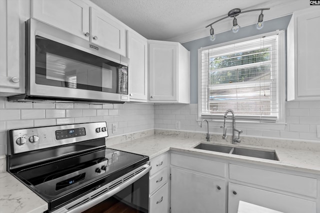 231 Horseshoe Cir, Columbia, SC 29223 - kitchen with stainless steel appliances, a textured ceiling, white cabinets, tasteful backsplash, and light stone countertops