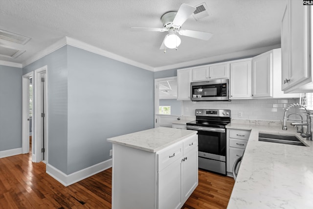 231 Horseshoe Cir, Columbia, SC 29223 - kitchen with stainless steel appliances, tasteful backsplash, white cabinets, dark wood finished floors, and crown molding