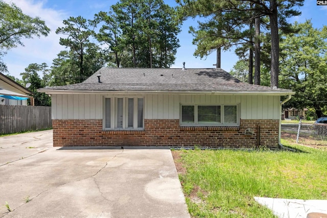 231 Horseshoe Cir, Columbia, SC 29223 - view of front of home with brick siding, a patio area, and a shingled roof
